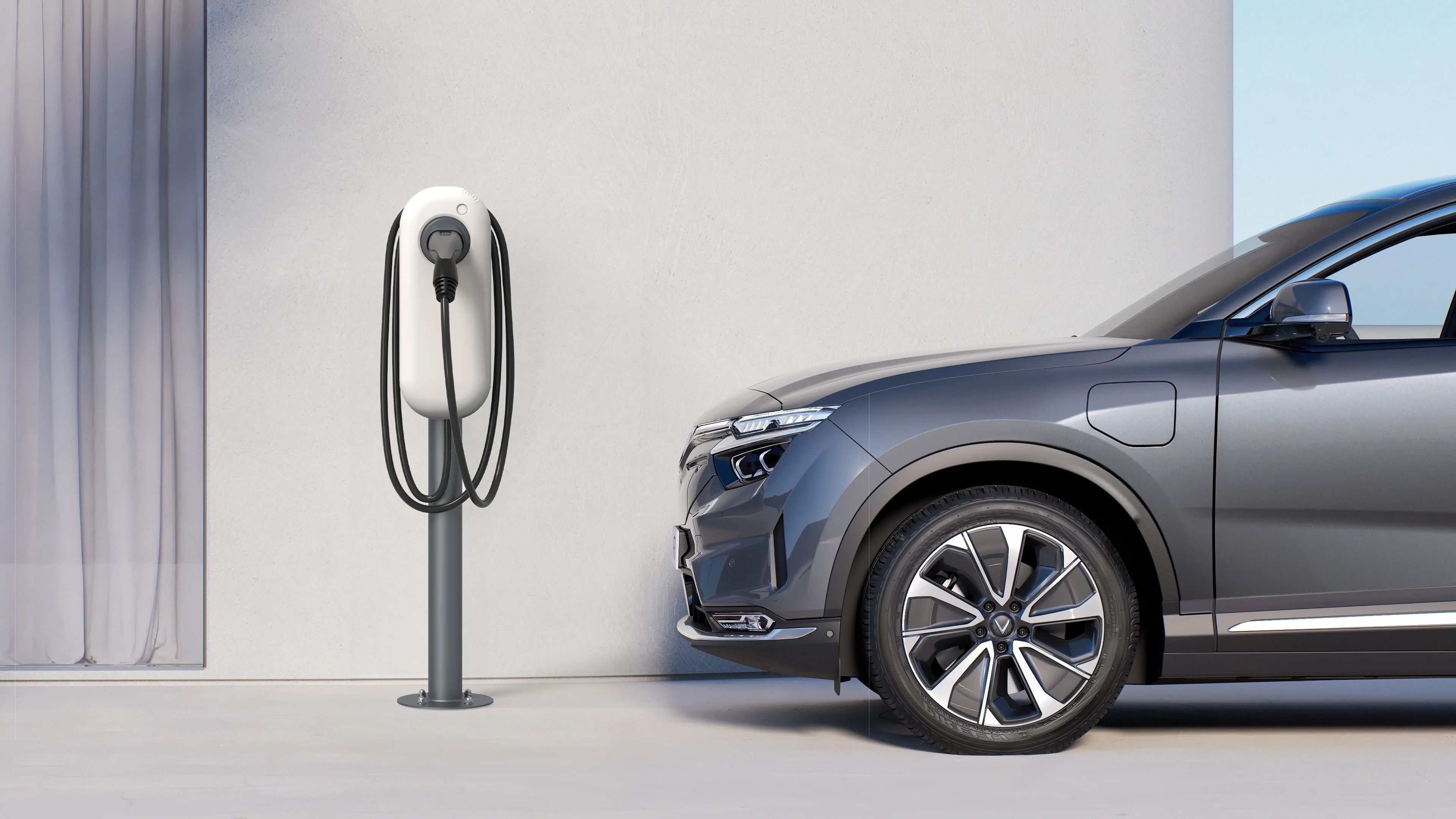 VinFast VF 8 electric SUV charging at a home wall charger station