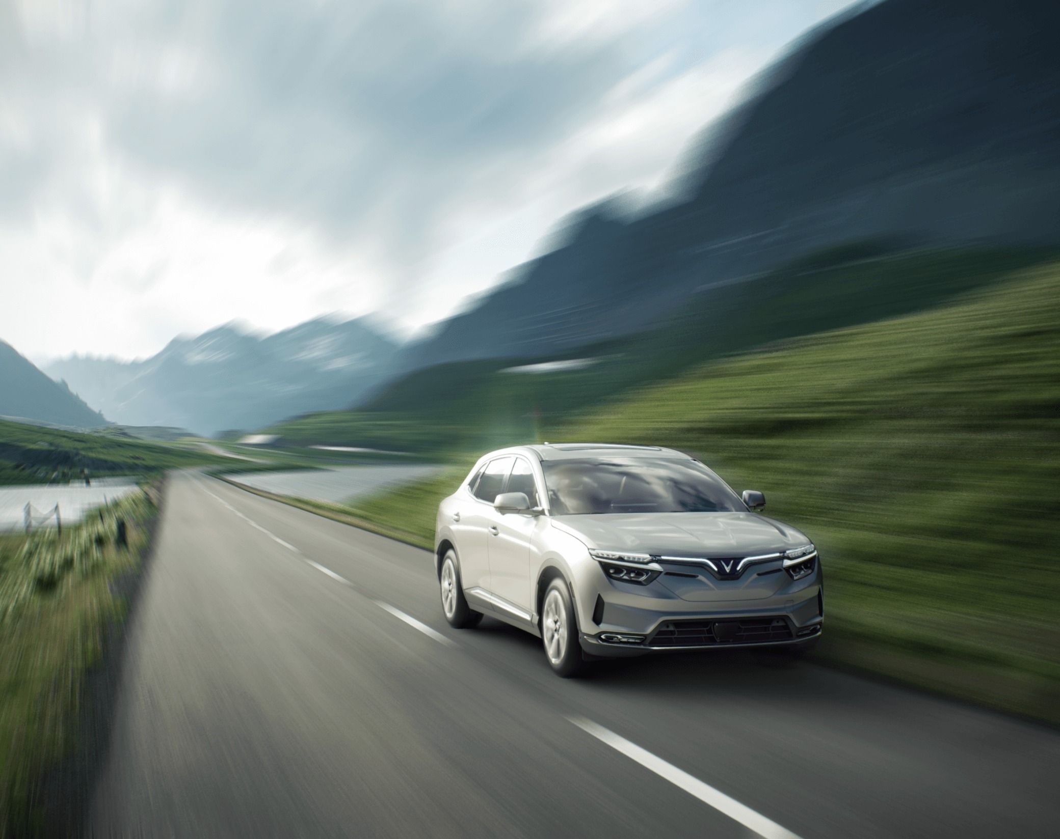 VinFast VF 8 electric SUV driving on a scenic mountain road