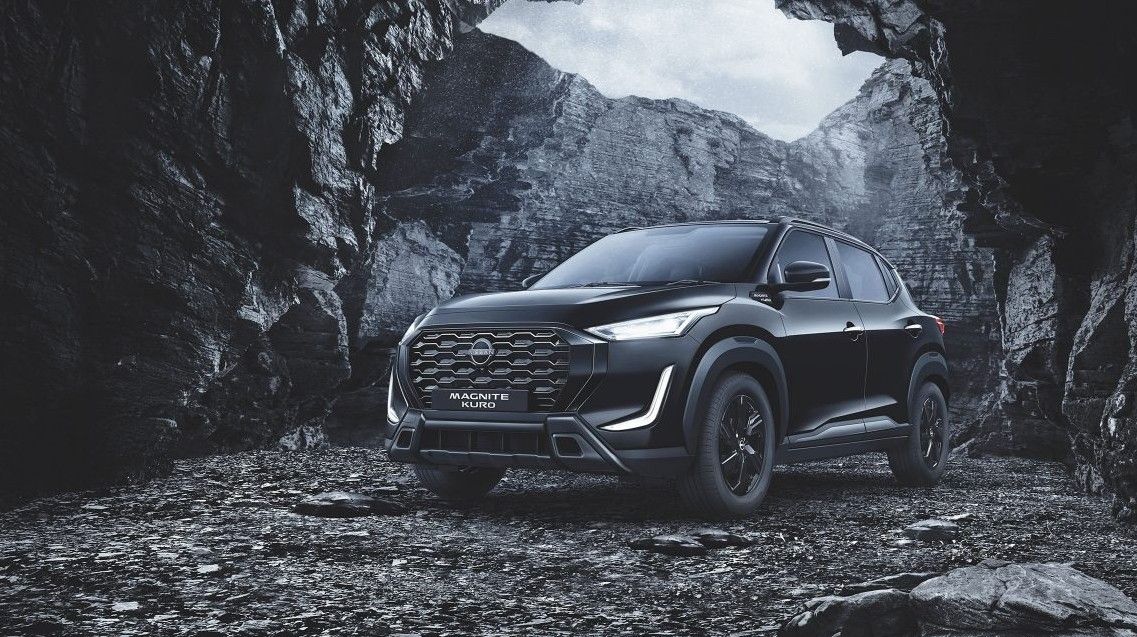 Nissan Magnite Kuro Edition in all-black finish parked inside a rocky cave, showcasing its bold SUV design and signature LED lighting.