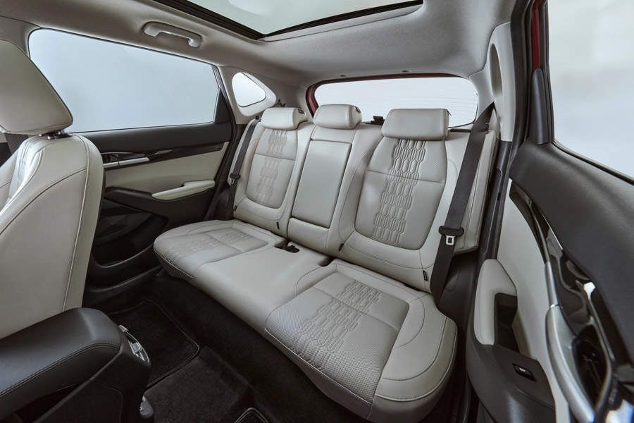 Kia Seltos rear seats with spacious cabin and panoramic sunroof.