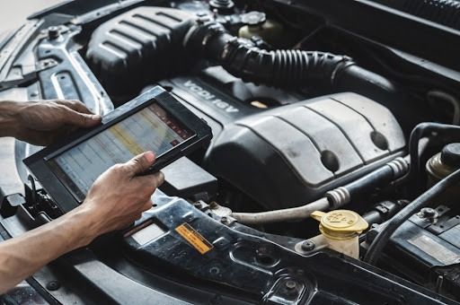 A mechanic scanning the car for engine faults