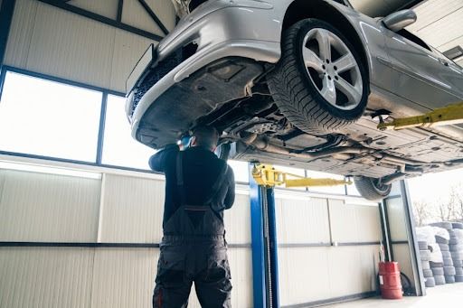 A mechanic checking the tyre alignment and tyre setting