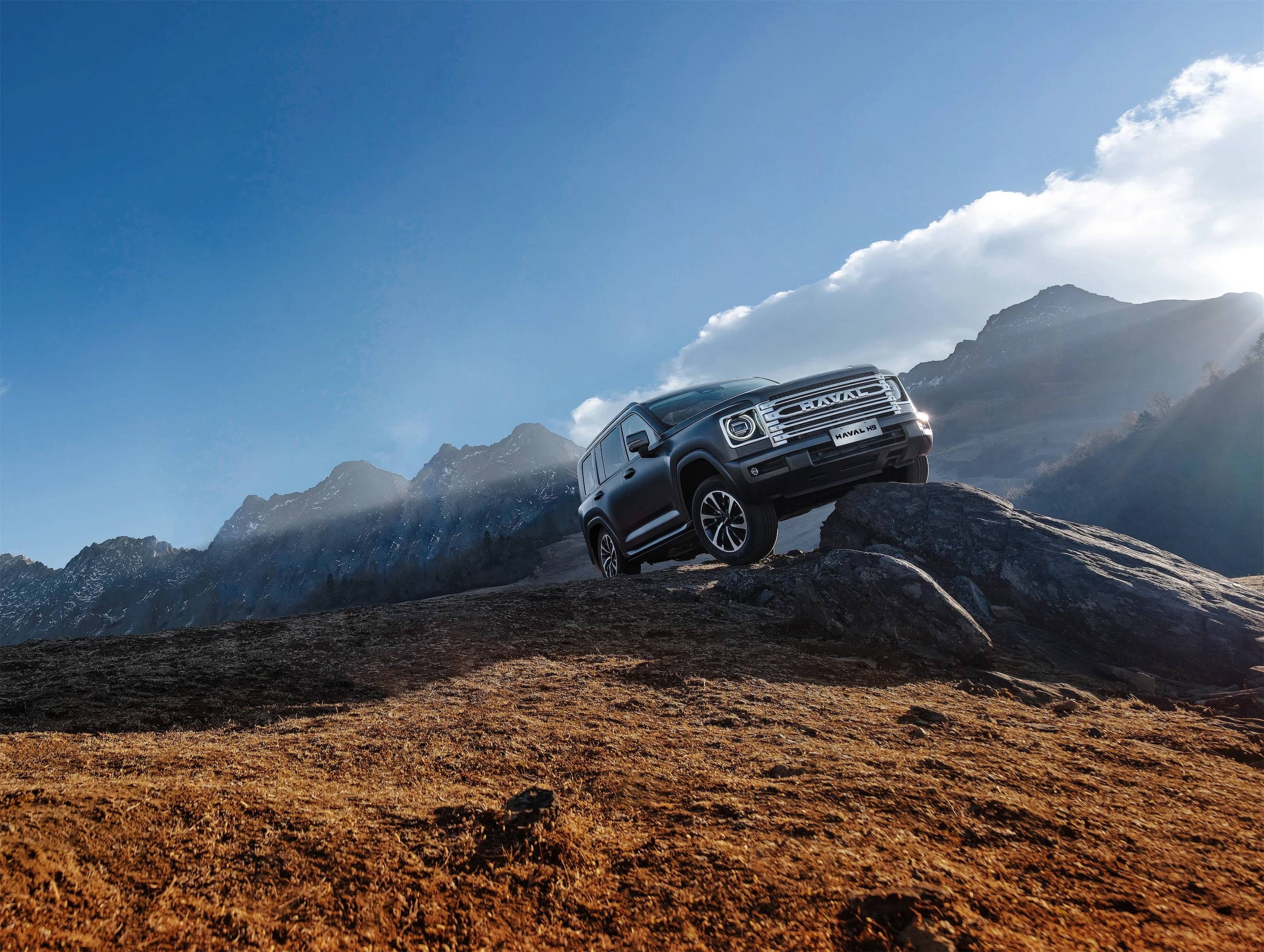 Haval H9 SUV climbing rocky terrain, showcasing its rugged off-road capability