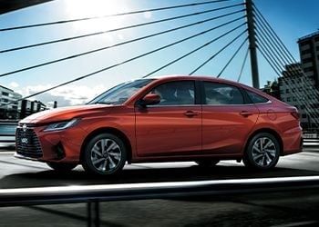 Red 2026 Toyota Yaris sedan with sporty fastback styling