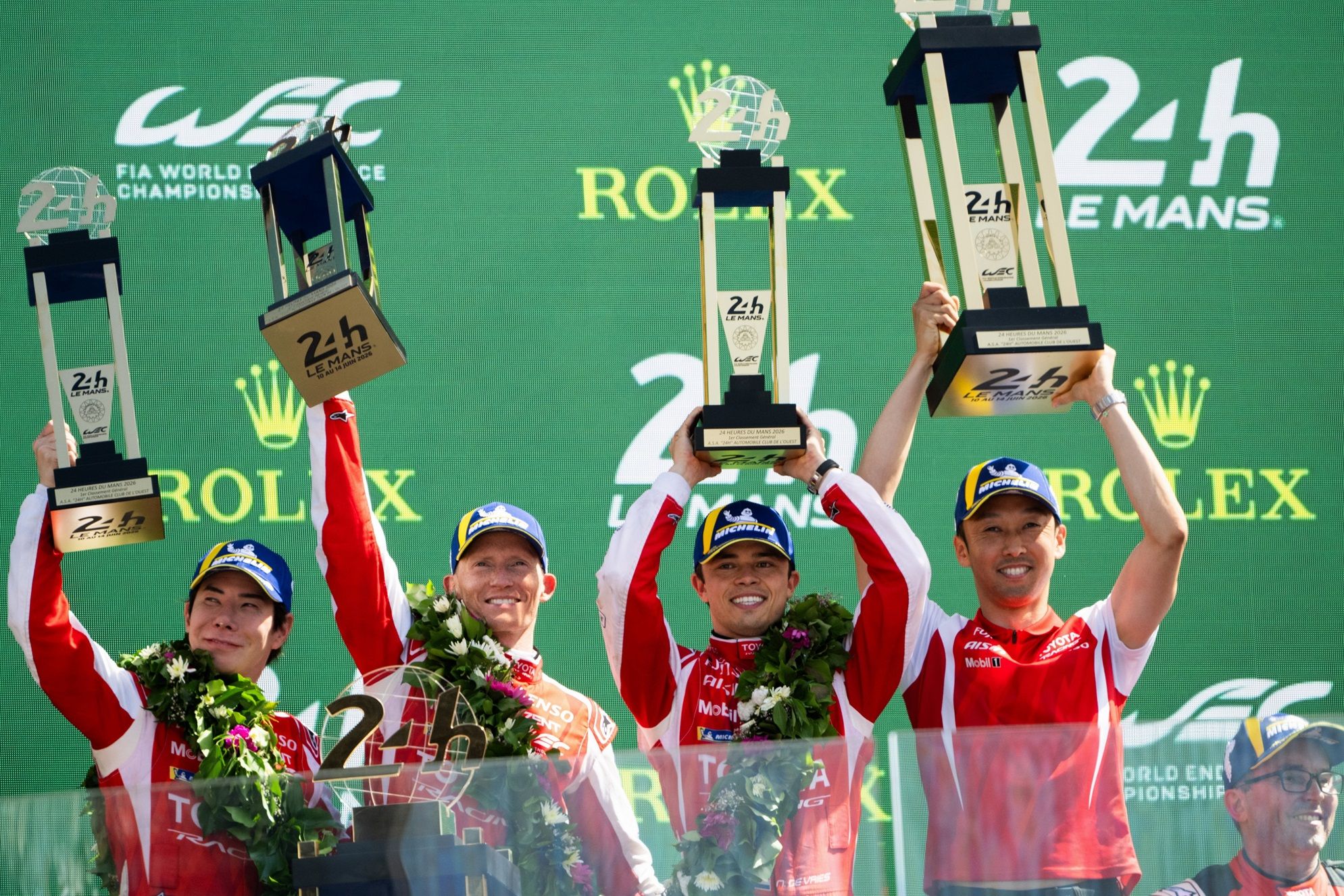 TOYOTA RACING drivers celebrate on the podium after winning the 2026 24 Hours of Le Mans.
