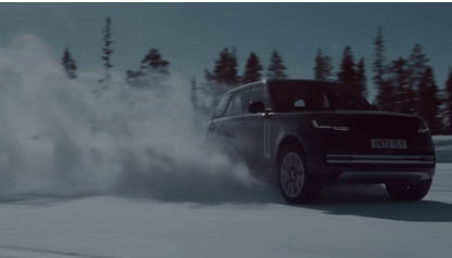 Range Rover driving through snow, showcasing all-terrain capability