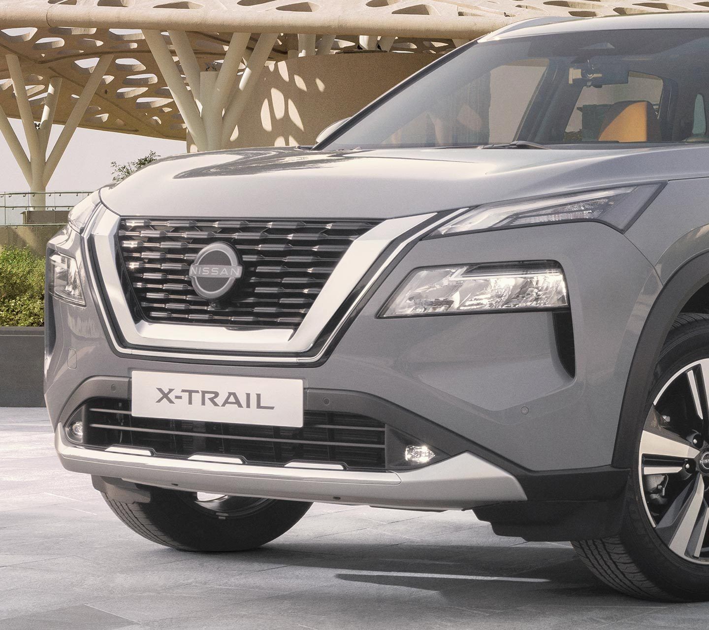 Nissan X-Trail front view with mountain lake backdrop