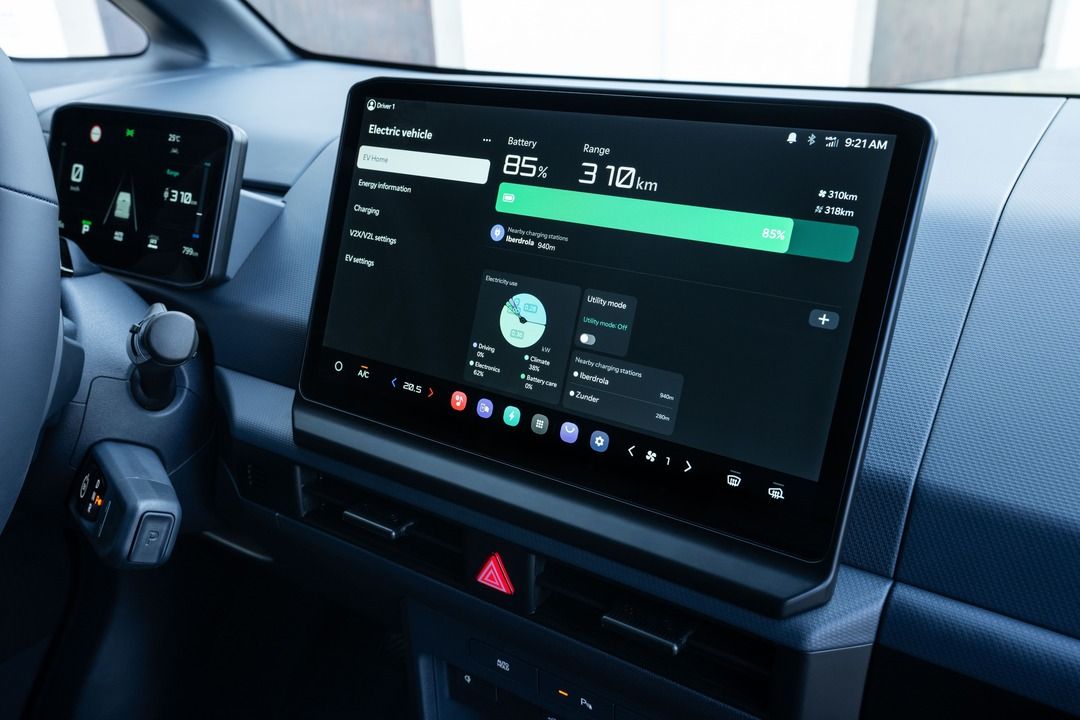 Kia PV5 infotainment display showing EV battery status, 310 km range and charging information on the central touchscreen.