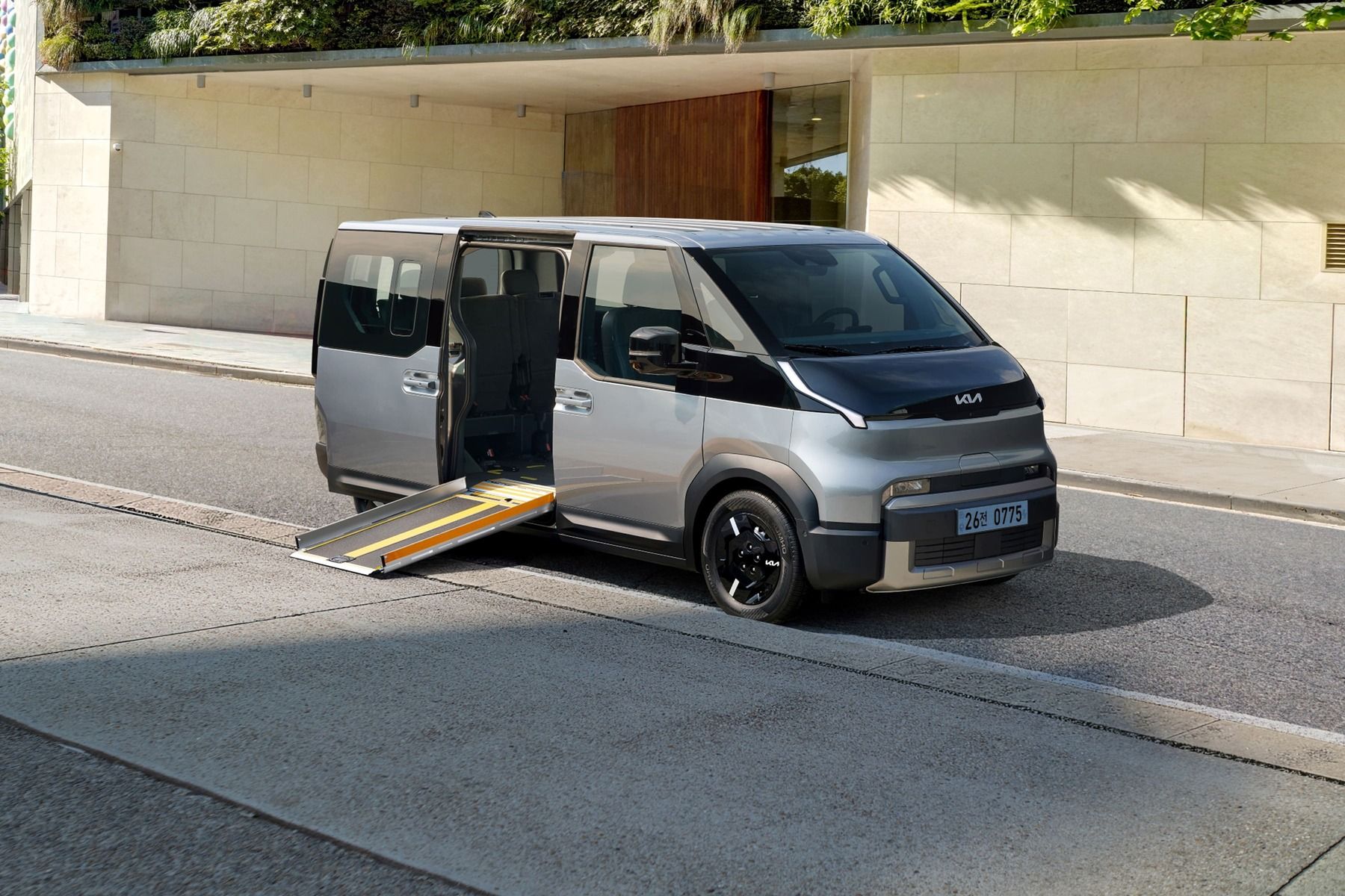 Kia PV5 Passenger parked on a scenic roadside, showcasing its exterior design and electric people-mover positioning.