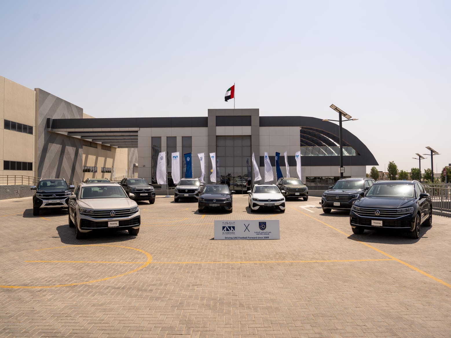 The new Volkswagen fleet, including Touareg, Teramont, Amarok and Jetta models, lined up outside Al Nabooda Automobiles as part of the UAE Pro League partnership.