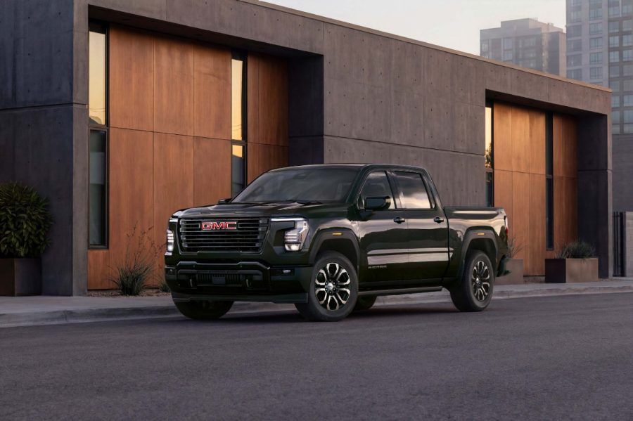 Front three-quarter view of the 2027 GMC Sierra Elevation parked outside a modern building.