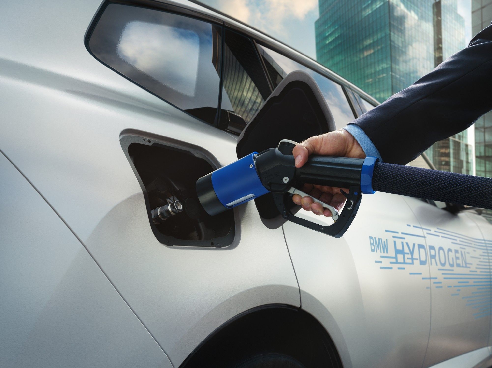 BMW iX5 Hydrogen being refuelled with hydrogen at a dedicated filling station.