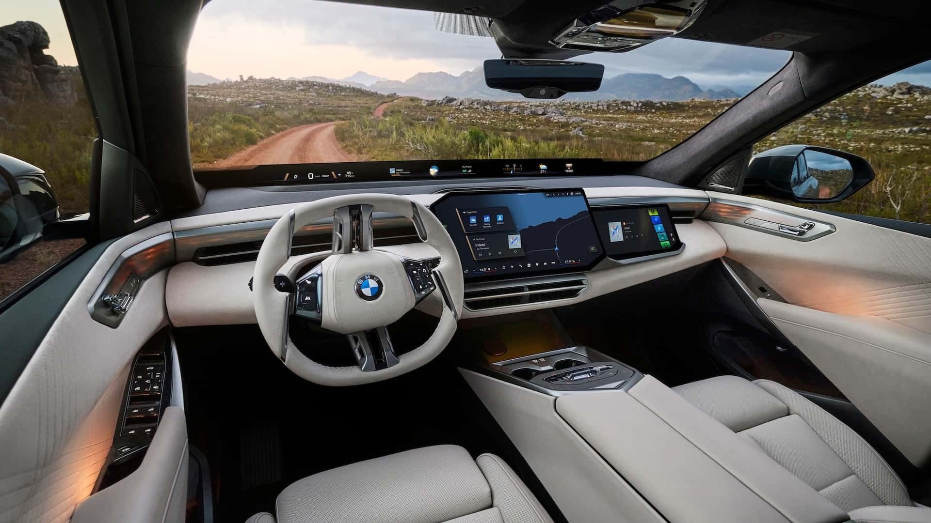 Luxury interior of the BMW X5 with white upholstery, panoramic Vision Display and premium dashboard layout.