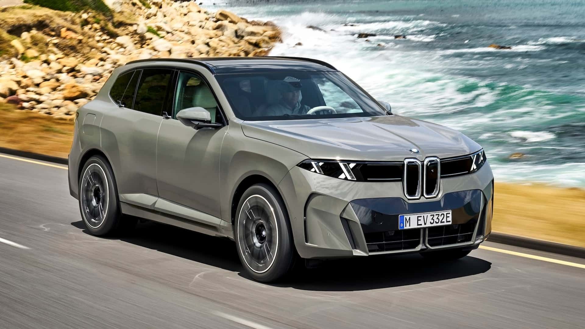Front three-quarter action shot of the BMW X5 highlighting the illuminated kidney grille and double-X LED headlights.