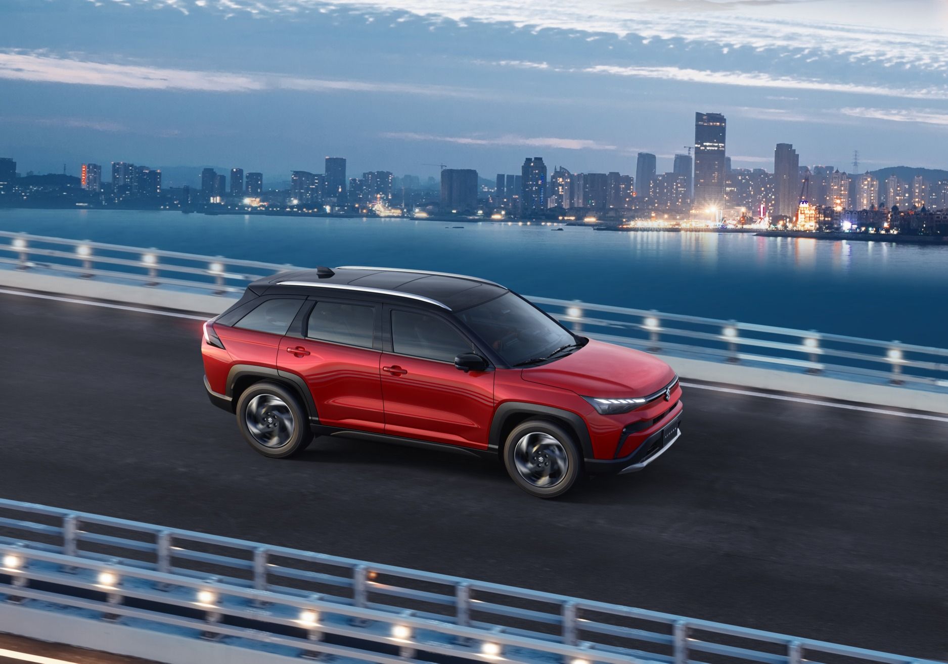Suzuki Across Hybrid driving on a city bridge highlighting its mild-hybrid performance