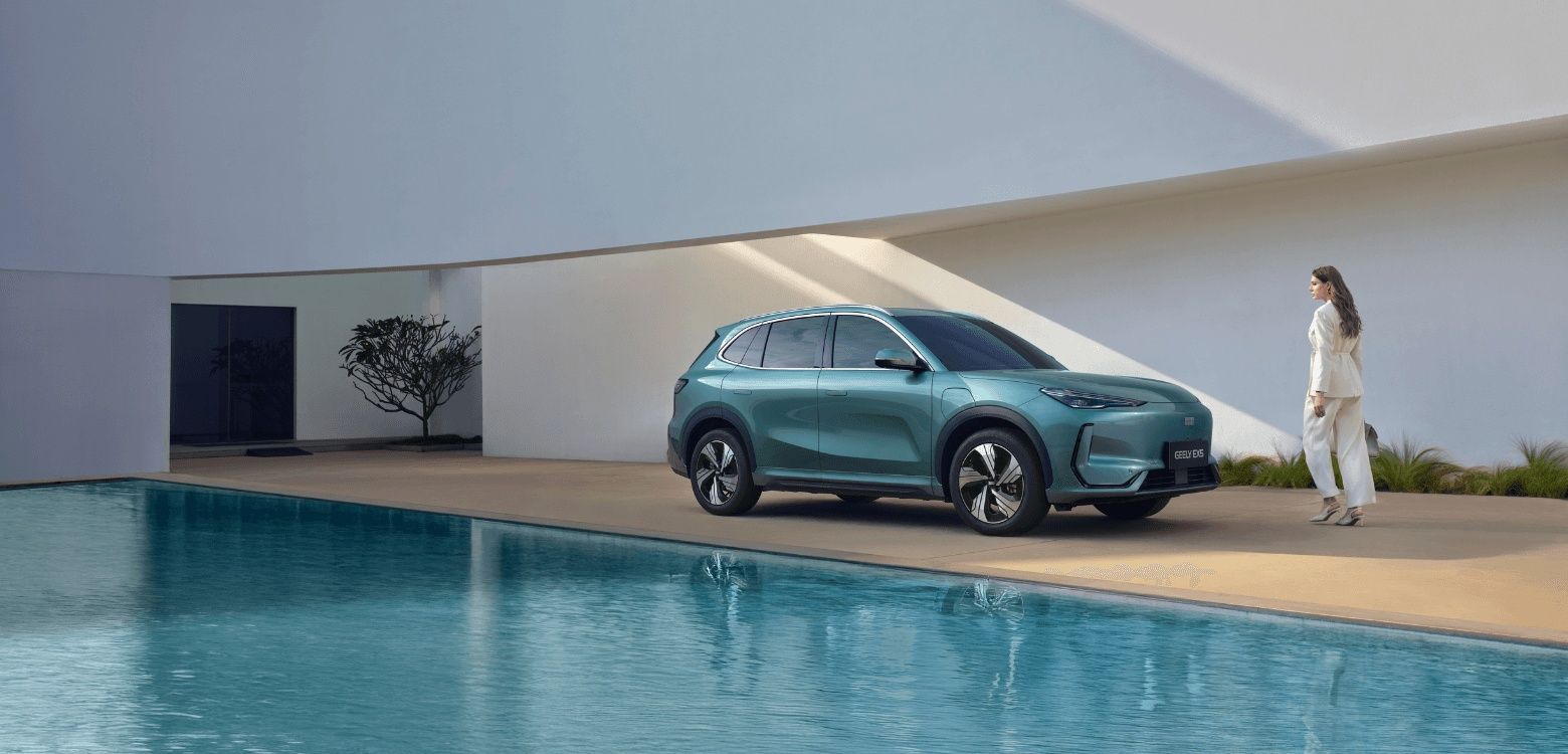 Geely EX5 parked beside a modern home, highlighting its stylish electric SUV design
