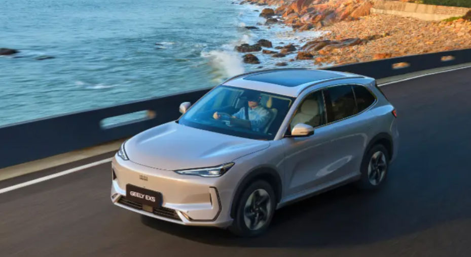 Geely EX5 electric SUV driving on a coastal road