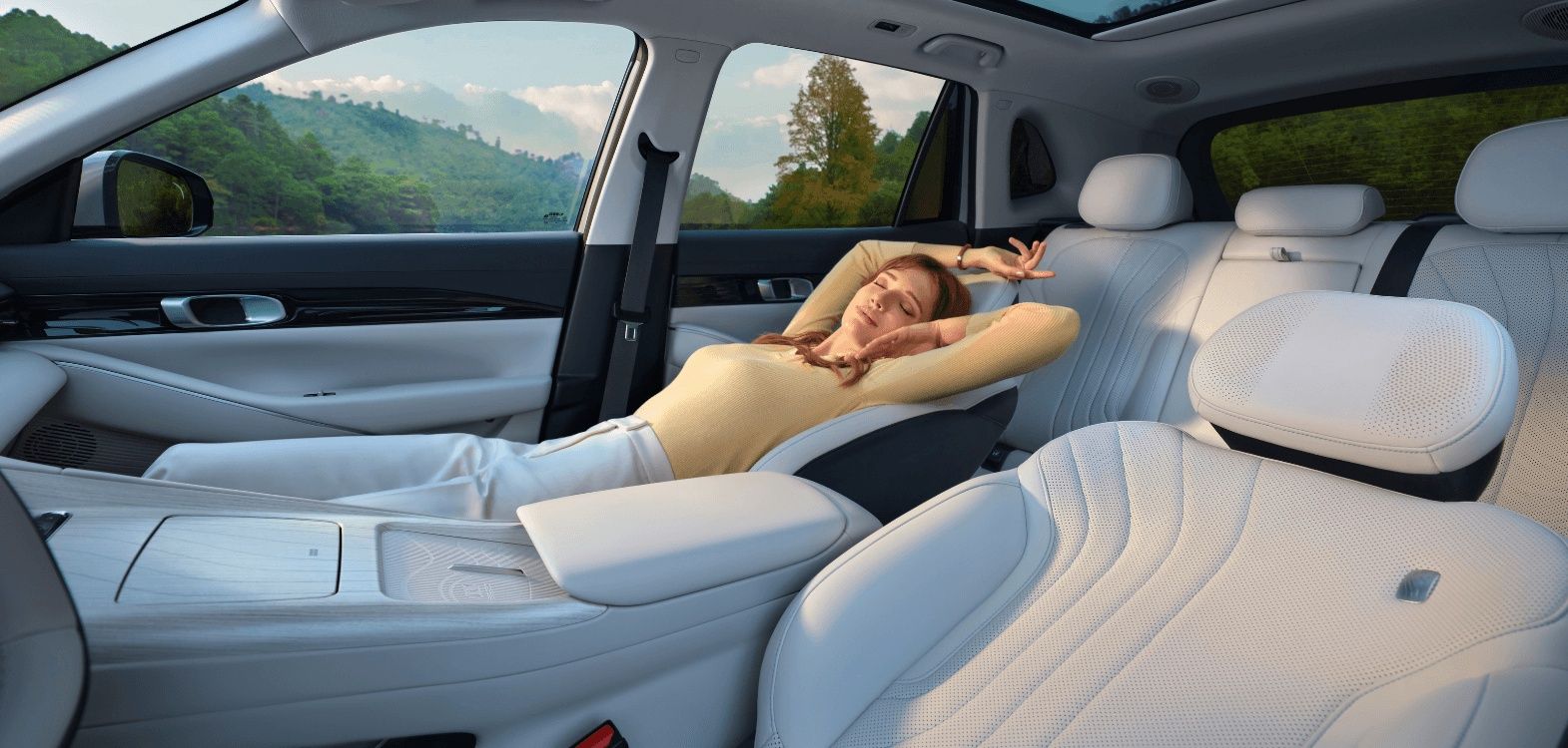 Geely EX5 Max+ interior featuring reclining seats, panoramic sunroof, and spacious premium cabin