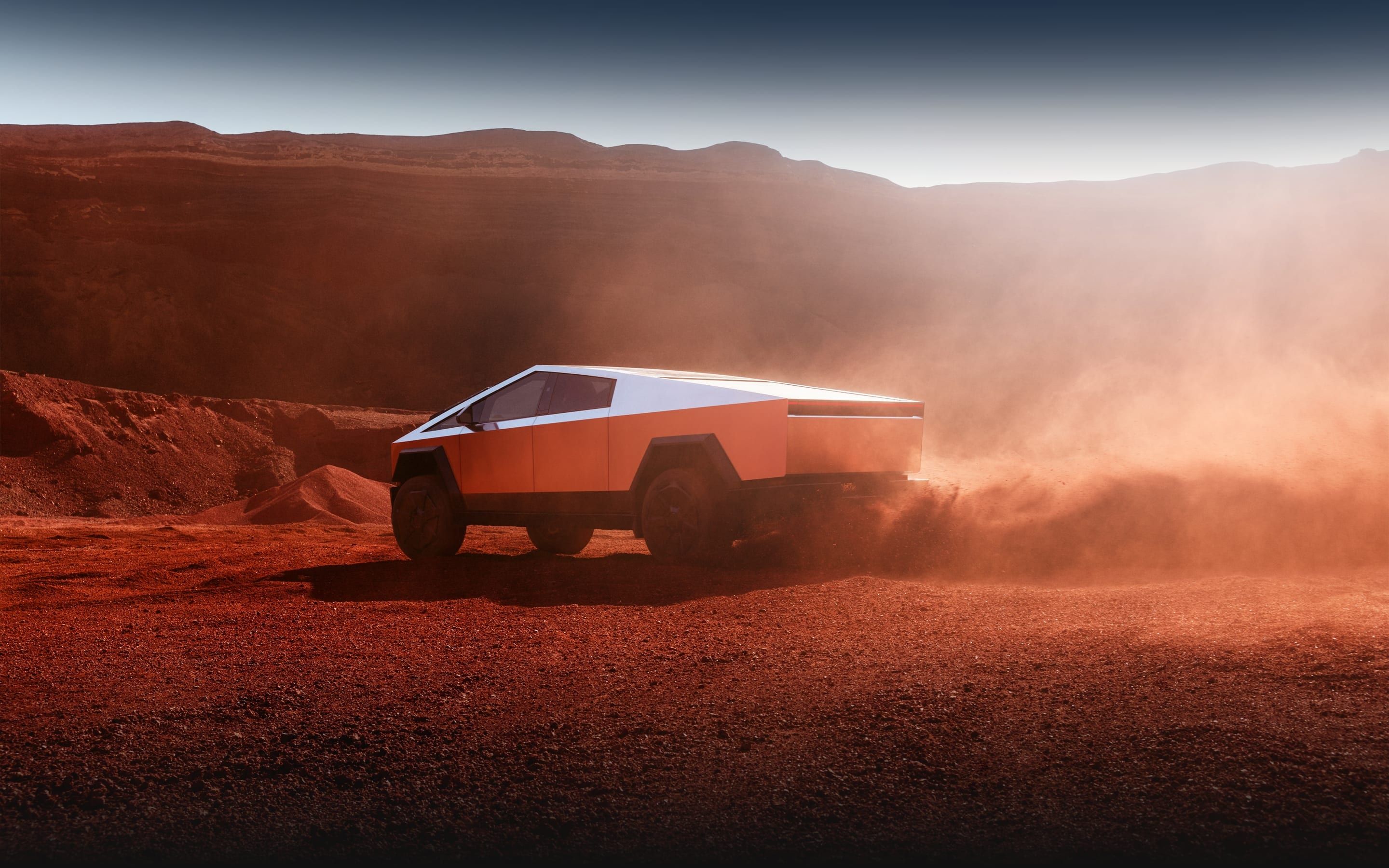 Tesla Cybertruck driving through rugged desert terrain showcasing electric off-road capability