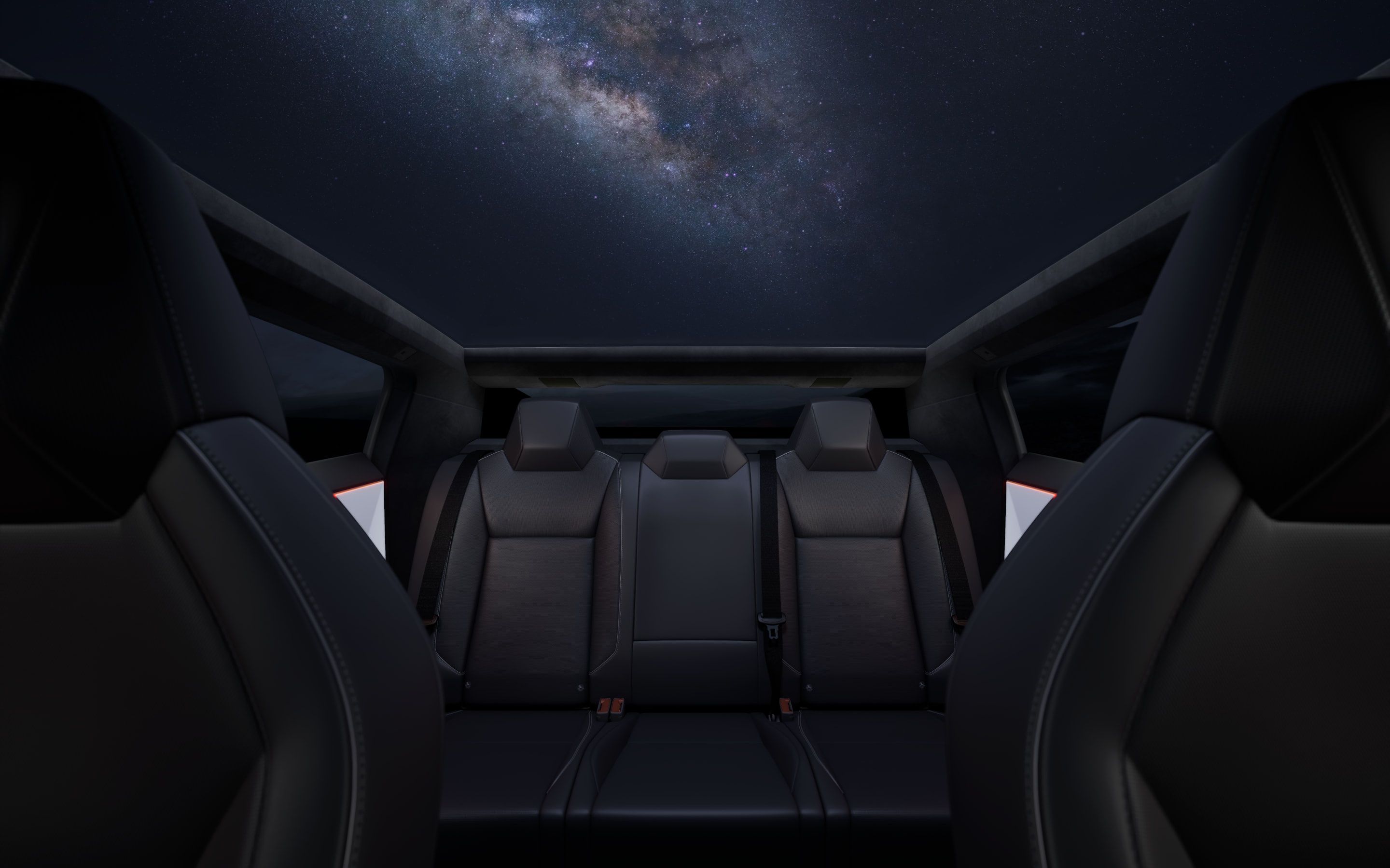 Tesla Cybertruck panoramic glass roof with spacious rear cabin under a starry night sky