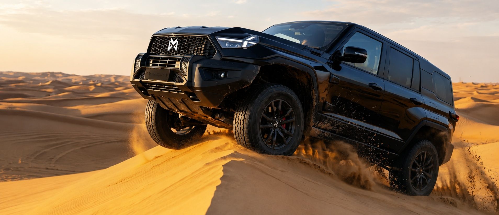 MHERO 1 premium off-road SUV climbing a sand dune in the desert