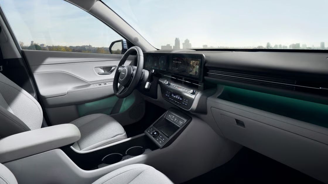 Hyundai Kona Electric interior featuring dual digital displays, ambient lighting, and a modern dashboard layout.