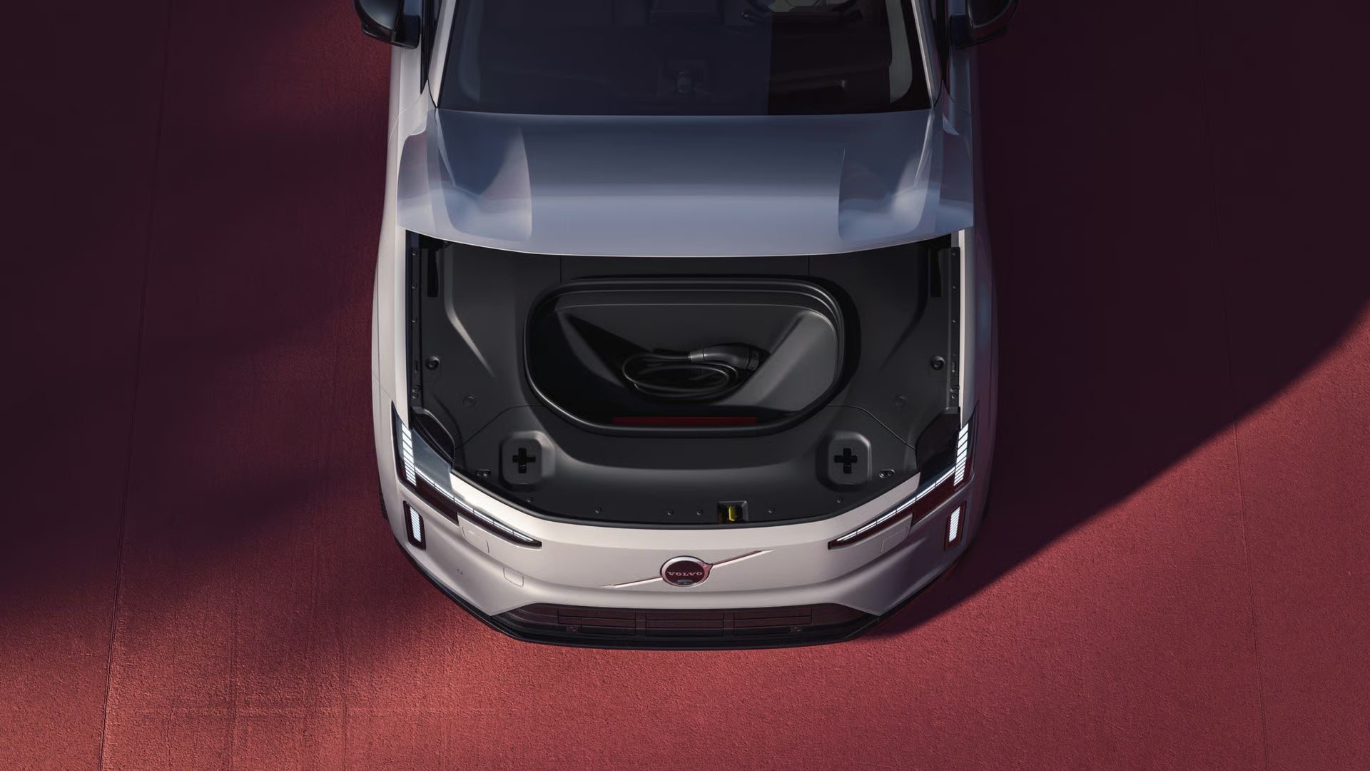 Volvo ES90 electric sedan parked outside a modern building
