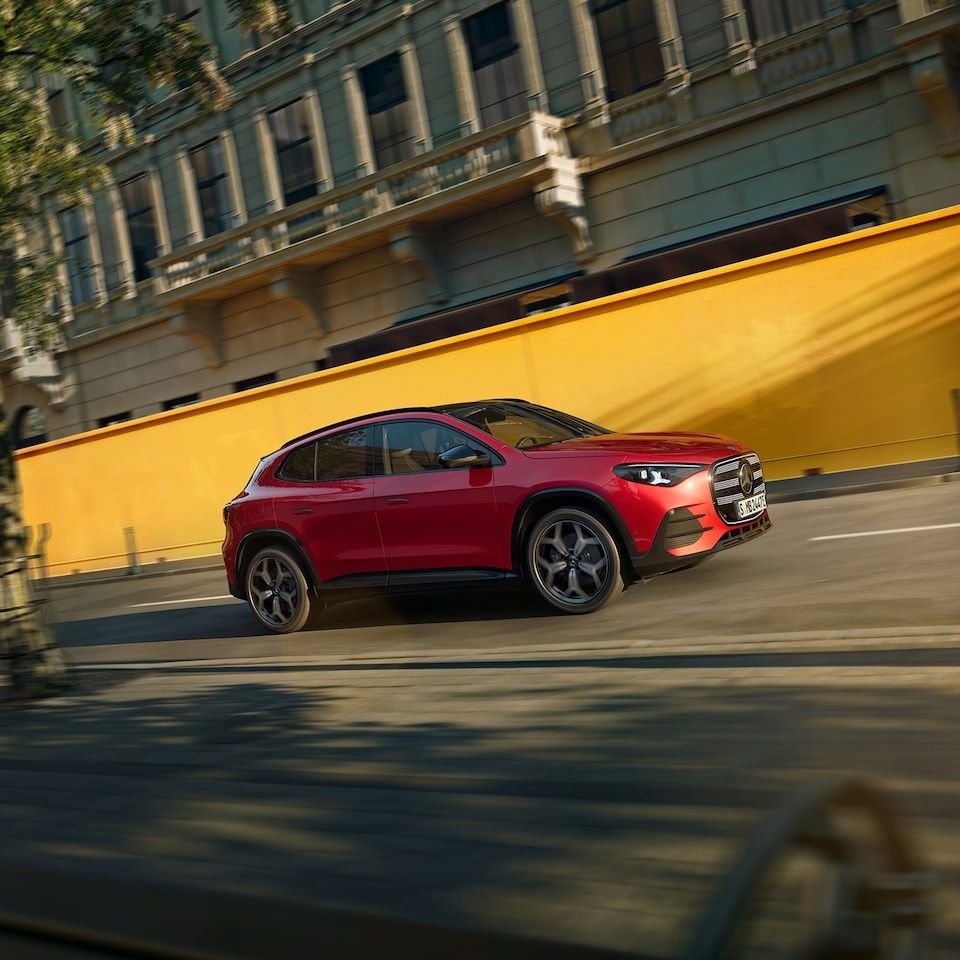 Mercedes-Benz GLA driving through the city with its sleek electric-first SUV styling