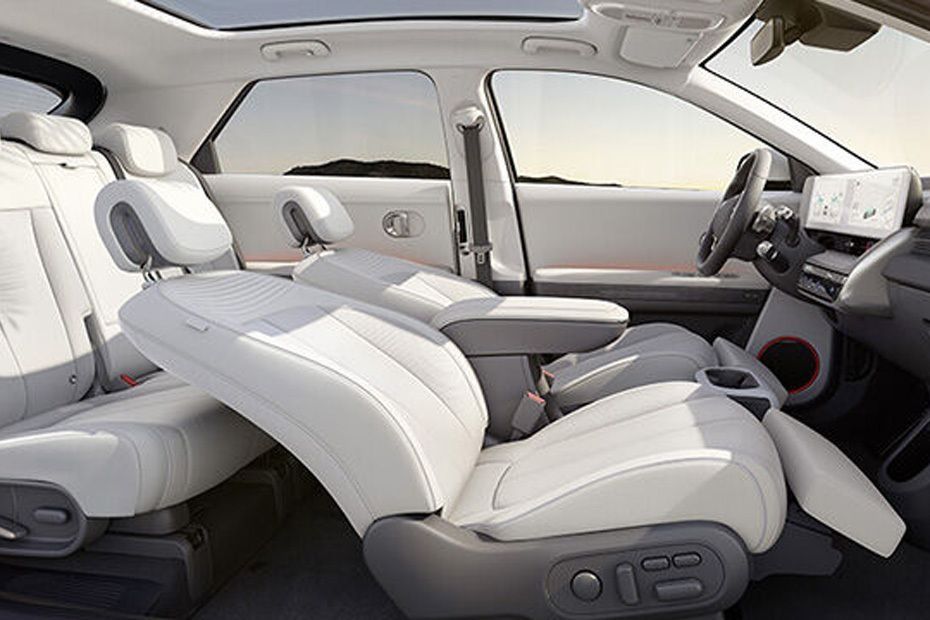 Hyundai IONIQ 5 interior with reclining front seats, sliding centre console and spacious cabin.