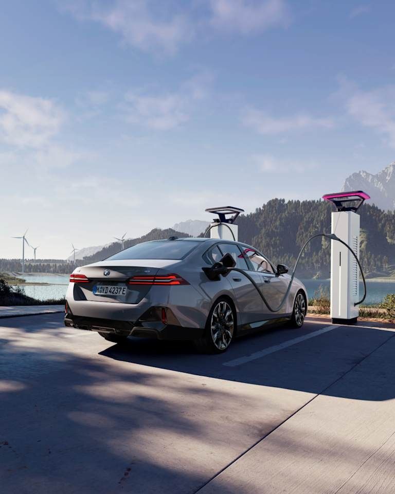 BMW i5 charging at a public EV charging station