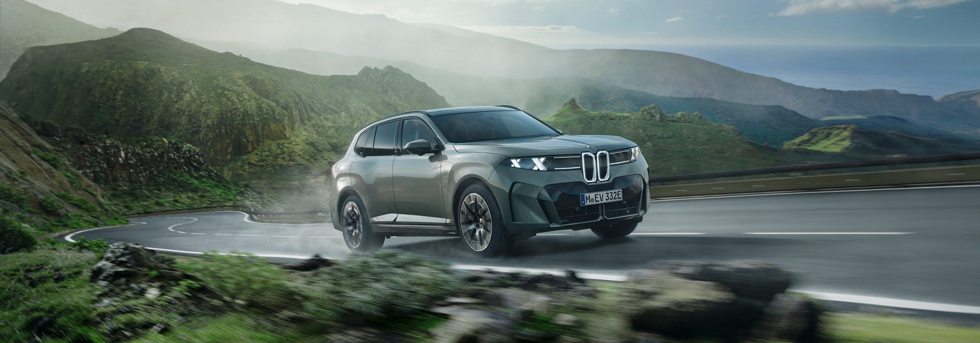 BMW X5 SUV driving on a scenic road