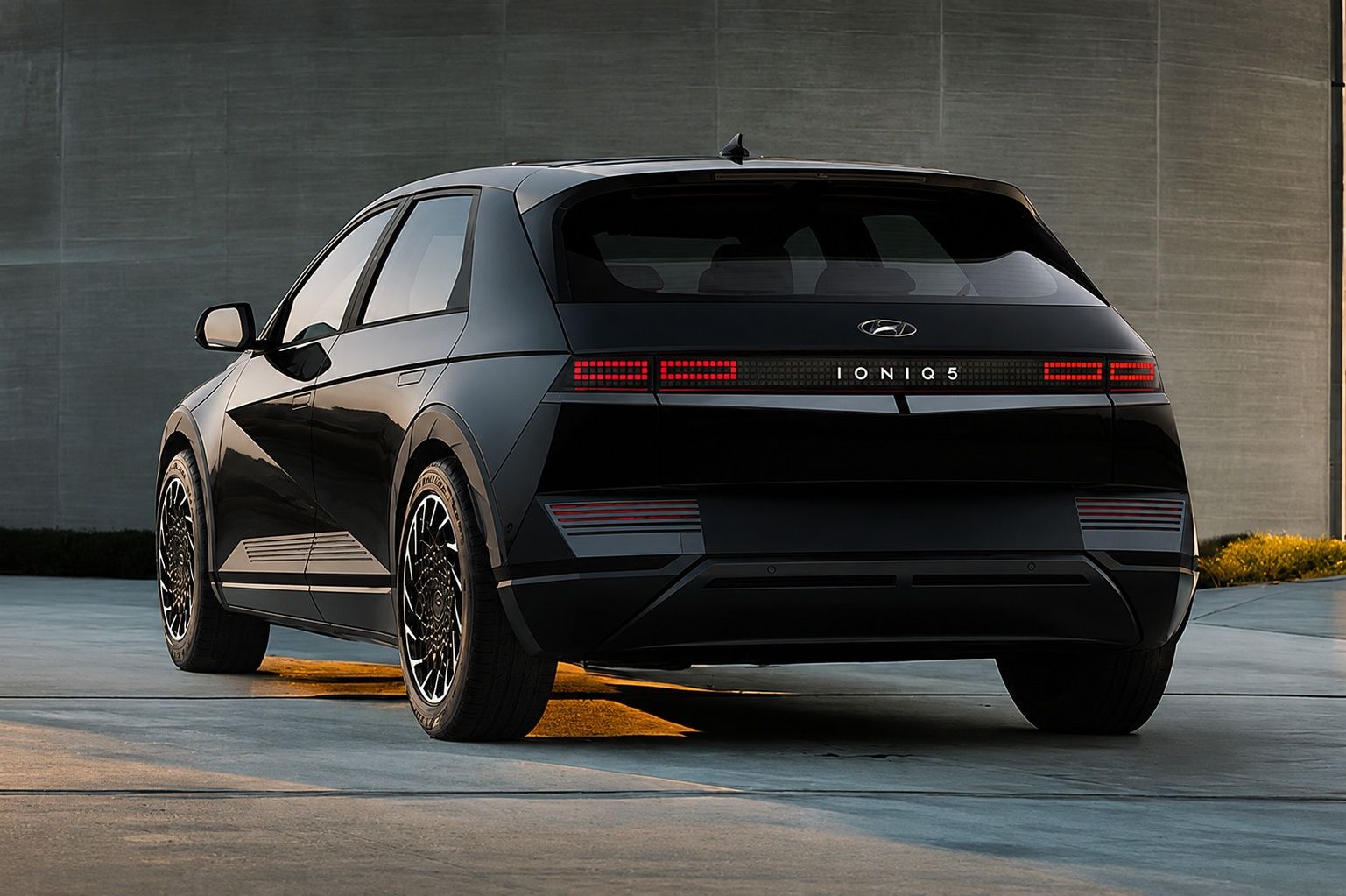 Hyundai IONIQ 5 in Phantom Black shown from the rear three-quarter view