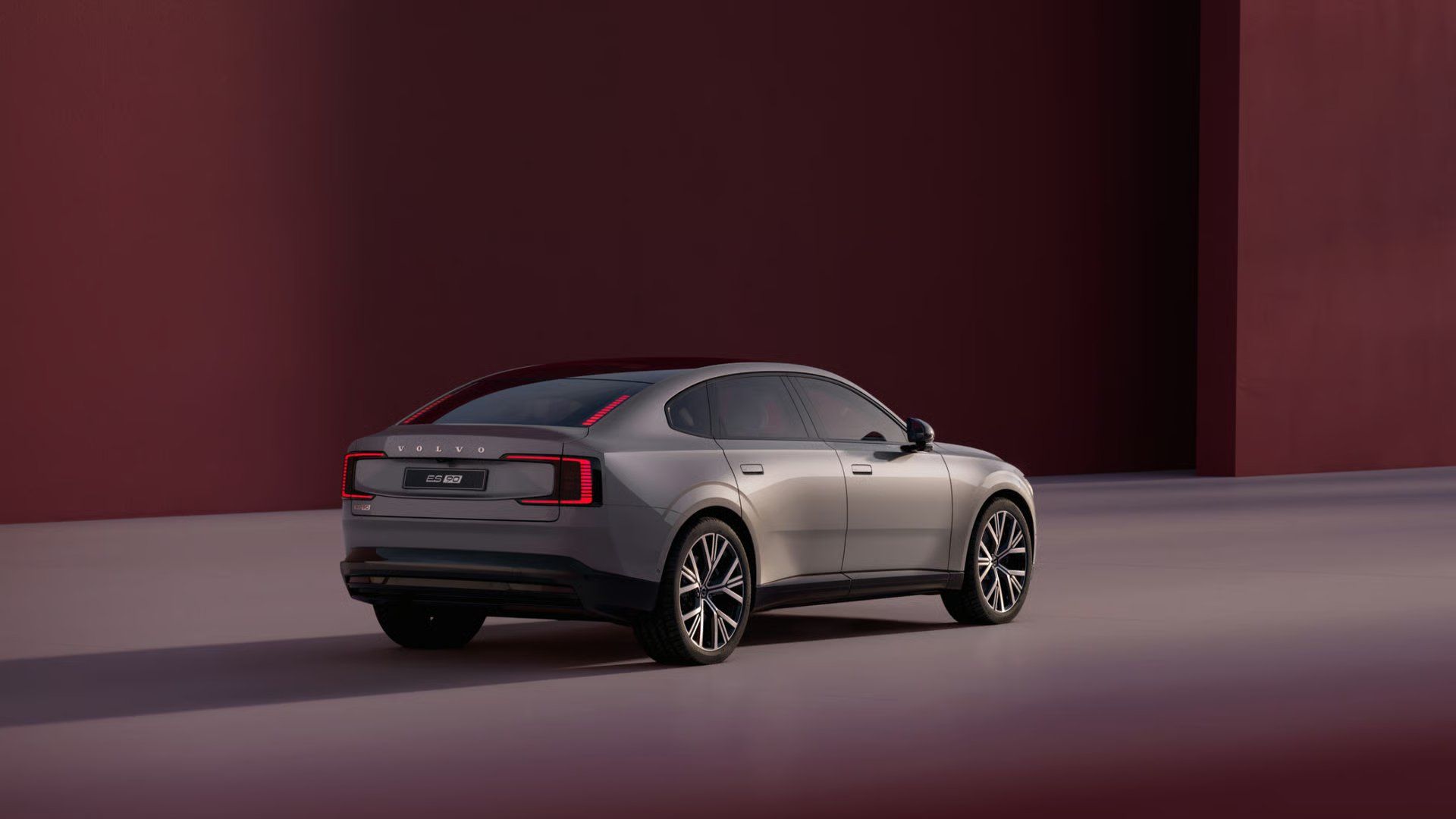 Volvo ES90 rear three-quarter view with distinctive LED tail lights.
